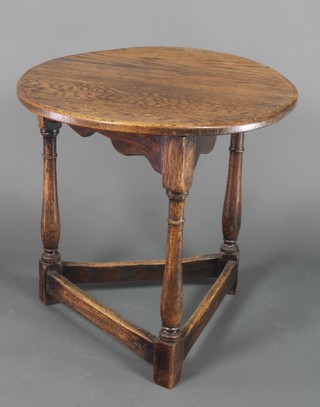 A Victorian circular elm cricket table with shaped apron, raised on turned and block supports with X framed stretcher 24"h x 24"w
