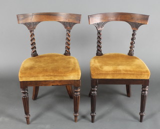 A pair of William IV Scots? rosewood bar back dining chairs with concave shaped bars supported by spiral columns and drop in seats, raised on turned and reeded supports 
