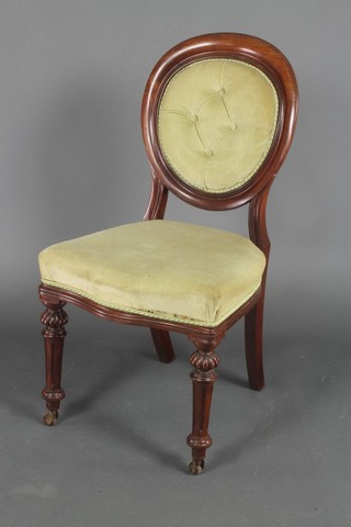 A Victorian mahogany balloon back chair with upholstered seat and back, raised on turned and fluted supports 