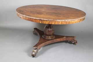 A Victorian circular figured mahogany snap top breakfast table, raised on a bulbous column and triform base ending in scrolled feet 30"h x 51 1/2"diam.  