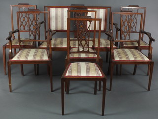 An Edwardian 7 piece inlaid mahogany drawing room suite comprising double chair back settee, 2 carver chairs and 4 standard chairs with lattice work slat backs and upholstered seats, on square tapering supports