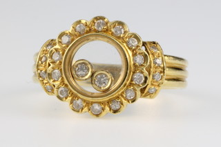 An 18ct gold Chopard style yellow gold diamond set ring with 2 floating diamonds, size L 