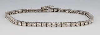 An 18ct white gold 54 stone diamond tennis bracelet 7" 