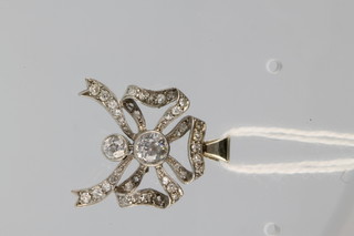 A white gold gem set ribbon pendant 