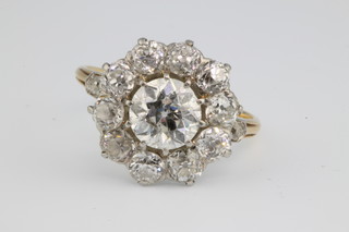 An 18ct yellow gold diamond cluster ring, the centre brilliant approx 1.5ct surrounded by 10 brilliants each 0.20ct with a brilliant to each shoulder, size O