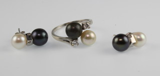 An 18ct white gold black and white pearl ring set with diamond shoulders, size L 1/2 and a pair of ensuite black and white pearl earrings 