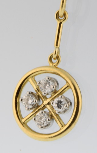 A yellow gold diamond set open pendant