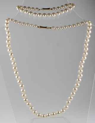 A string of cultured pearls together with an ensuite bracelet with 14ct gold clasp 