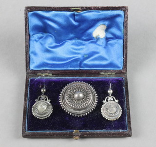 A Victorian silver Etruscan brooch and matching earrings contained in a fitted case 