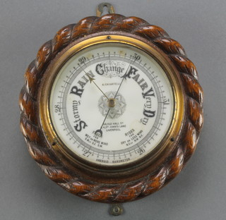 A Casartellie of 54 Old Hall Street and 4 St Johns Lane Liverpool.  An aneroid barometer with enamelled dial, contained in a carved oak case with rope edge decoration 