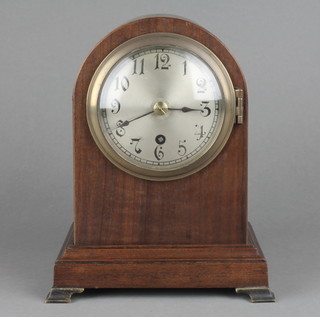An Edwardian bracket timepiece with silvered dial and Arabic numerals contained in an arched mahogany case raised on metal bracket feet, the back plate marked W & H SCH