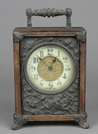 A Victorian bedroom timepiece with enamelled dial and Arabic numerals contained in a mahogany and embossed metal case 