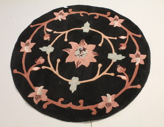 A black ground Indian floral patterned circular rug 30" diam. 