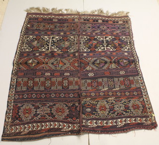 A blue and red Kilim rug with stylised guls 73" x 63"