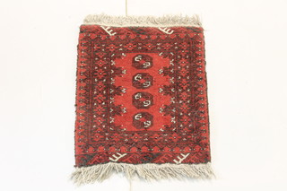 A red ground Afghan slip rug with 4 octagons to the centre 27" x 19 1/2" 