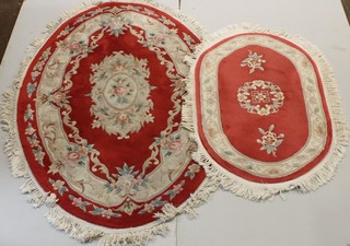 An oval red ground and floral patterned Chinese carpet 76" x 51" and 1 other 51" " x 33" 