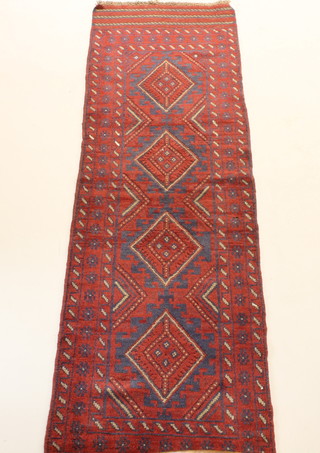 A Meshwani red ground runner with 4 diamonds to the centre 97"l x 27"w  