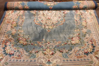 A blue and floral patterned Chinese carpet 158" x 118 1/2", some staininig