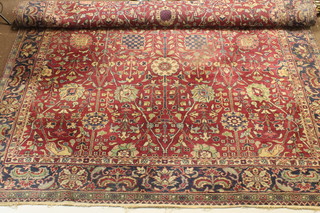 A red and blue ground floral patterned Persian carpet 142" x 107" (slight moth)
