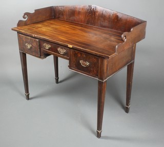 A Victorian mahogany wash stand with raised three-quarter gallery, satinwood stringing, fitted 1 long and 2 short drawers, raised on square tapering supports, spade feet 37 1/2"h x 42"w x 22"d 