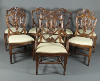 A set of 8 Hepplewhite style mahogany shield backed dining chairs with upholstered drop in seats, raised on square tapering supports, spade feet
