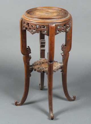 A circular Chinese carved and pierced hardwood 2 tier jardiniere stand, raised on outswept supports 27"h x 12" diam.