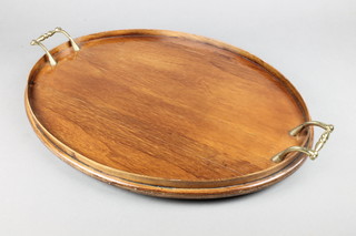 An oval mahogany twin handled tea tray 21 1/2"w x 16"d