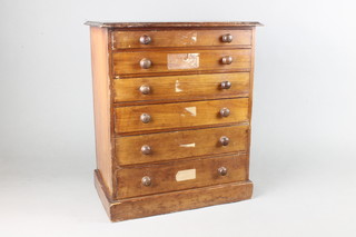 A Victorian pine collectors chest of 6 long drawers with tore handles, raised on a platform base 18"h x 15"w x 9 1/2"d 