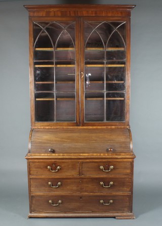 A 19th Century mahogany cylinder bureau bookcase, the upper section with moulded cornice, fitted shelves enclosed by arch panelled astragal glazed doors, the cylinder revealing a fitted interior above 2 short and 2 long drawers raised on ogee shaped bracket feet 872h x 42"w x 21 1/2"d (made up)