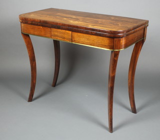 A Regency D shaped inlaid brass card table raised on sabre supports 29"h x 36"w x 18"d 