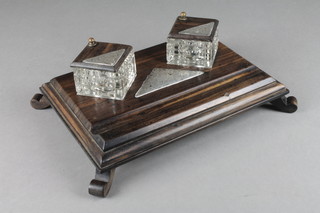 An Edwardian coromandel, glass and silver standish fitted 2 square cut inkwells with silver plaques raised on a rectangular base with pen recess, raised on scroll supports  3"h x 10"w x 11"d hallmarked London 1905