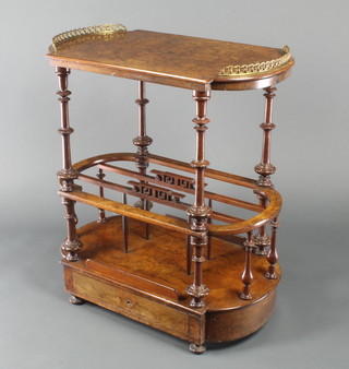 A Victorian oval and inlaid figured walnut Canterbury, the upper section with crescent shaped brass gallery, the base fitted 3 divisions and drawer to the base 29"h x 26 1/2"w x 15 1/2"d 