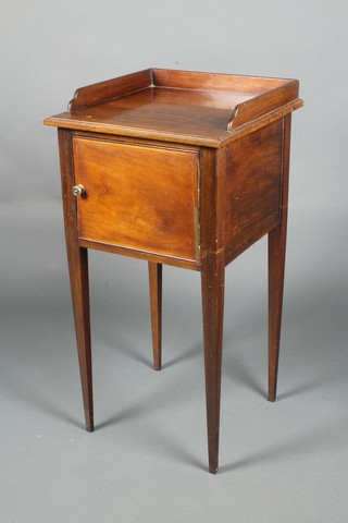 A Georgian style mahogany bedside cabinet with three-quarter gallery enclosed by a panelled door, raised on square tapered supports 32 1/2"h x 16 1/2"w x 16"d