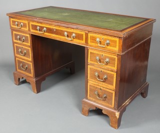 An Edwardian inlaid mahogany pedestal desk with inset leather writing surface and crossbanded top, fitted 1 long and 8 short drawers with brass swan neck drop handles, raised on bracket feet 29"h x 47"w x 23 1/2"d 