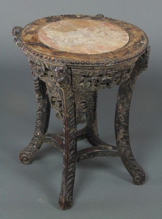 A circular Chinese hardwood jardiniere stand with pink veined marble top, raised on shaped supports 18"h x 14" diam. 