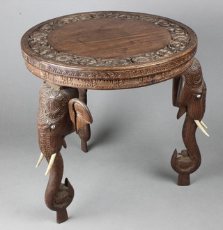 A circular carved Indian hardwood occasional table raised elephant supports 15"h x 14 1/2"diam. 