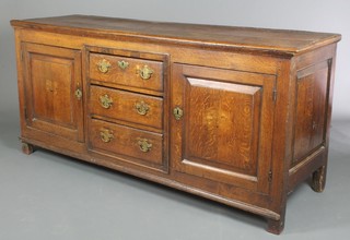 A Georgian oak dresser base fitted 3 drawers above a pair of cupboards 32"h x 72"w x 21"d 