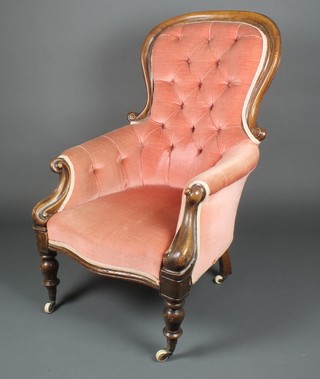 A Victorian bleached mahogany show frame armchair upholstered in buttoned pink dralon on cabriole supports