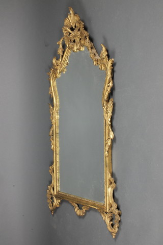 An arched shaped plate wall mirror contained in a carved gilt wood frame 50 1/2"h x 29"w 