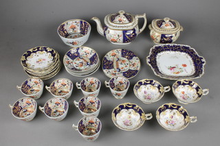 A Rockingham style 19th Century tea set decorated in the Imari taste comprising teapot, 12 cups, 11 saucers, side plate, slop bowl and sucrier with a sandwich plate