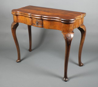 An 18th Century Continental walnut card table with crossbanded top of serpentine outline, the interior fitted counter wells, raised on cabriole supports fitted 1 long drawer 30 1/2"h x 36"w x 18"d 