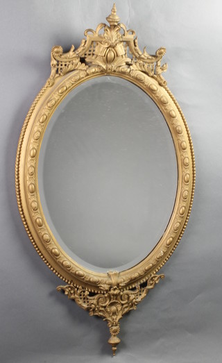 A 19th Century oval bevelled plate wall mirror contained in a gilt painted plaster frame 42" x 22"
