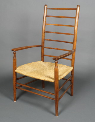 A William Morris style beech ladderback open arm chair with woven rush seat 