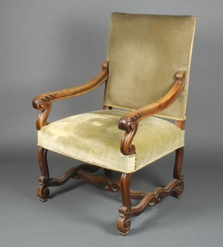A 17th Century style carved walnut open arm chair with H framed stretcher 