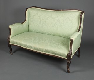 An Edwardian mahogany show frame sofa upholstered in green material, raised on cabriole supports 35"h x 49"w x 25"d 