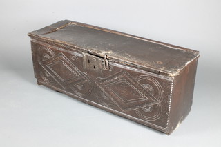 An 18th Century oak coffer of carved panelled construction, the interior fitted a candle box with iron lock 16"h x 42 1/2"w x 14"d  