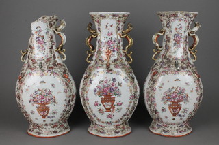 A good set of 3 18th Century flattened baluster vases with waisted necks and stylised dragon handles decorated with vases of flowers and insects, the moulded bodies with mice and scrolling flowers, 16" 
