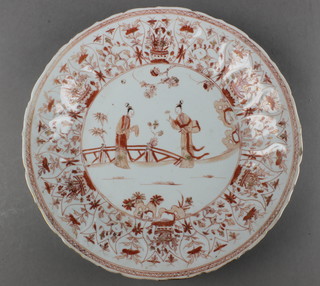 An 18th Century Chinese shallow dish with ochre decoration, having a central panel of ladies in a garden landscape surrounded by a border of insects and flowers 11" 