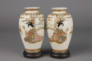 A pair of 20th Century Satsuma oviform vases decorated with figures in pavilion interiors 5" 