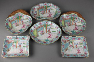 A 19th Century famille rose part dinner service with trellis and floral borders enclosing figures in pavilion landscapes comprising 2 shaped dishes, 2 rectangular dishes and 2 scallop shaped dishes